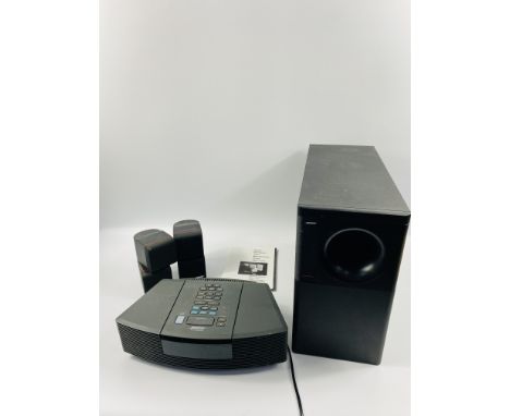 BOSE Wave radio/cd together with a BOSE Acoustimass 5 bass speaker and two small BOSE speakers. Estimate £30-50