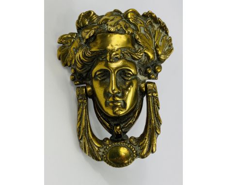 A heavy 19th century cast brass figural door knocker, 13 x 17cms. Estimate £20-30.