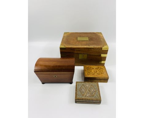 A 19th century rosewood tea caddy, with keys, 20cm wide; together a brass mounted writing box 30cm wide and two decorative bo
