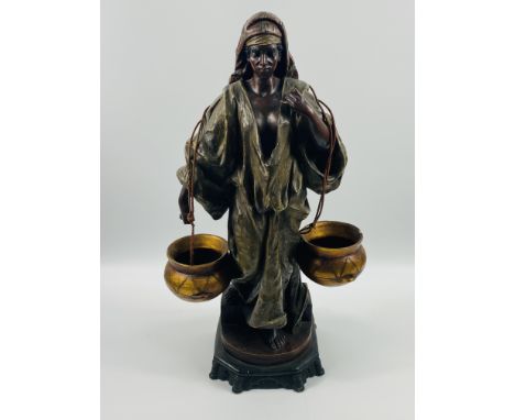 A Goldscheider style figure of a lady carrying two pots, initialled to underside, 57cm. Estimate: £60-80.
