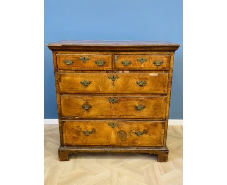 An early 18th century walnut chest of two short over three long drawers, with crossbanded and herringbone inlaid decoration, 