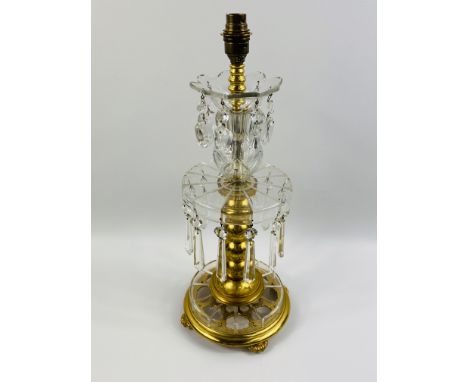 A large brass and glass table lamp, decorated with glass droplets with lustres below, with an engraved brass central column s