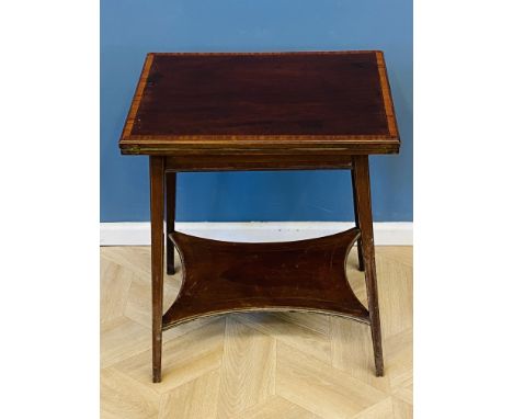 An Edwardian mahogany card table with a foldover top, and inset baize playing surface, satinwood banding and line inlaid deco