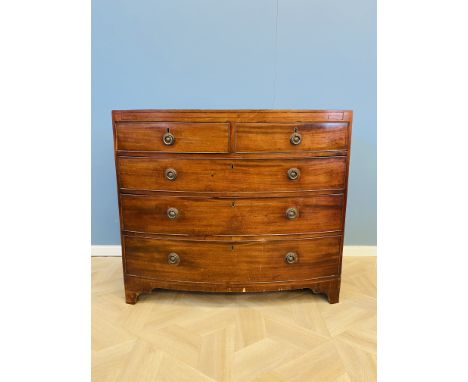 A 19th century mahogany bow front chest of drawers of two short over three long drawers, with inlaid and cross banded decorat
