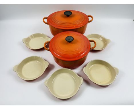 Two Le Creuset lidded casserole pots together with five Le Creuset skillet dishes. Estimate £20-40.