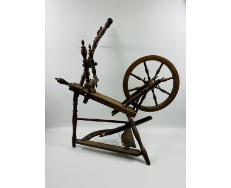 A late 19th century framed spinning wheel, 77 x 41 x 76cms. Estimate £15-30. This item carries VAT.