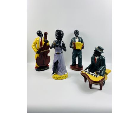 Four contemporary ceramic figures making up a band, comprising singer, piano player, cellist and accordion player, approximat