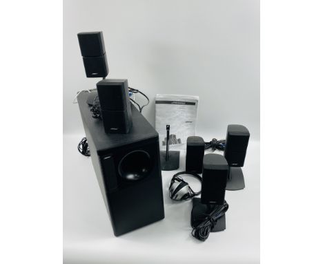 Bose Acoustimass 15 home theatre system, comprising bass speaker and five small speakers. Estimate £60-120.From the Estate of