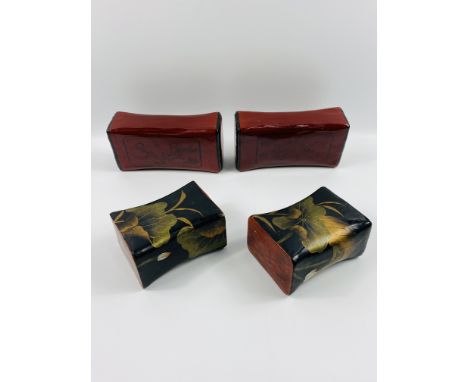 A small pair of Chinese black lacquered with gilt decoration pillows, with a seal mark to each end, 17 x 13 x 9cms; together 