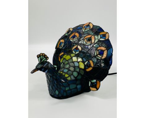A contemporary Tiffany style table lamp modelled as a peacock, 25 x 30 x 22cms. Estimate £20-30.