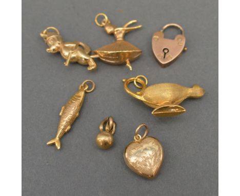 A Group of Seven 9ct. Gold Charms to include a lamp, a figure, a fish and others, 7.2 gms