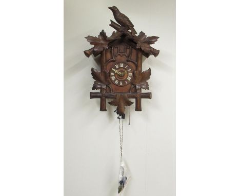 C20th pine and walnut Black Forest cuckoo clock, Roman dial with applied indices, unsigned two train weight driven movement, 