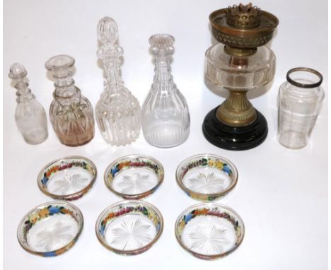 Four glass decanters, max. H30cm; six dessert bowls, each painted with fruit, gilded rims; C19th oil lamp with clear reservoi