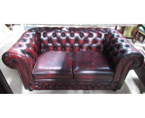 Thomas Lloyd red leather upholstered two-seat Chesterfield sofa, deep buttoned back and arms with loose seat cushions, W160 D