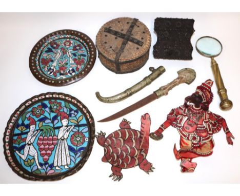 Magnifying glass with brass handle, L30cm; two leather shadow puppets; two brass and enamel chargers; Indian wood block print