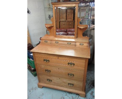 Edwardian ash dressing chest, with mirror and three shaped drawers above two short and three long drawers with Art Nouveau br