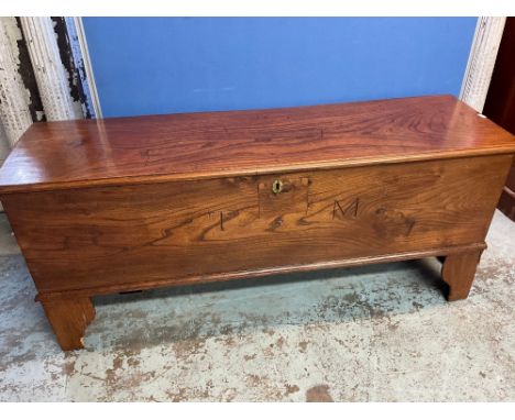 C19th elm planked coffer hinged top with two interior drawers and a concealed drawer, on bracket feet, front inscribed T M, W