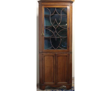 George 111 boxwood strung mahogany standing corner cabinet, gadrooned cornice and scrolled astragal moulded glazed door above