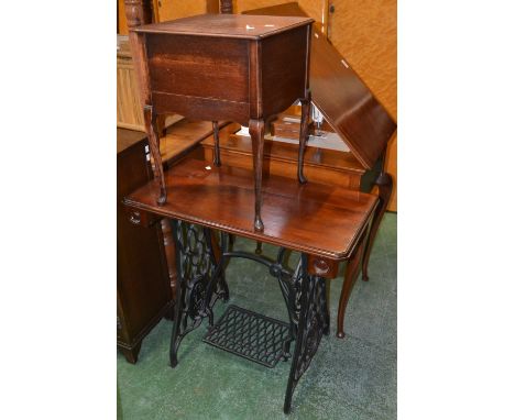 A Singer 760 sewing machine and table; a cast iron treadle sewing machine base converted to an occasional table; a 1940's sew