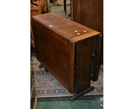 A 1940's oak dropleaf table, rounded rectangular top