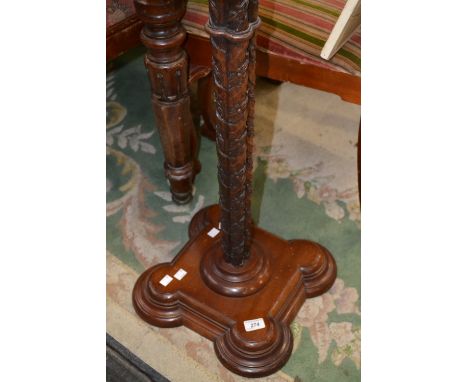 An early 20th century mahogany standard lamp, lobed column, leafy decoration in relief, circular socle, stepped square base w