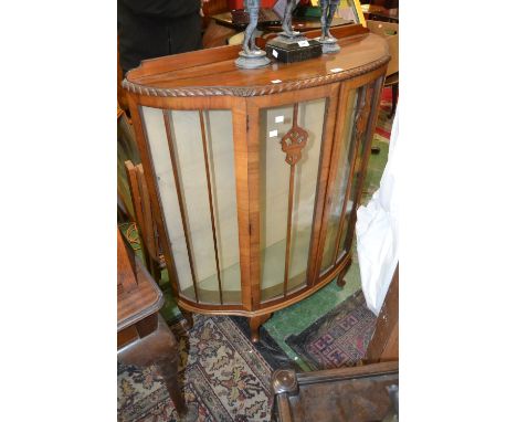 A 1940's bow front china display cabinet.