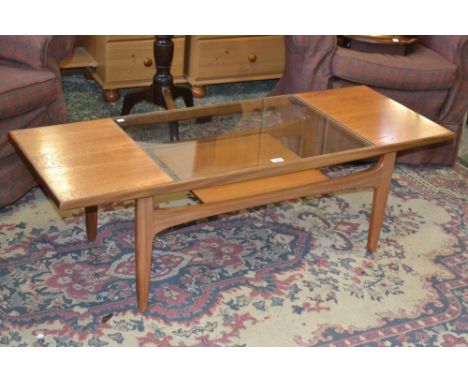 A 1950's/60's Ernest Gomme (G-Plan) teak coffee table with glass inset top, under tier shelf