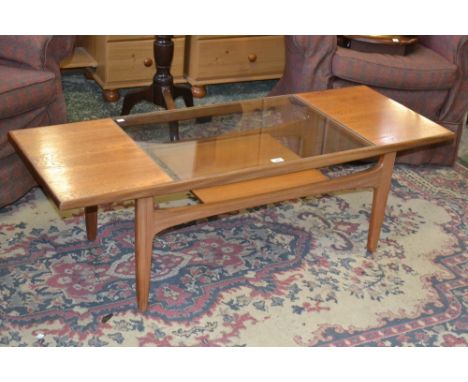 A 1950's/60's Ernest Gomme (G-Plan) teak coffee table with glass inset top, under tier shelf