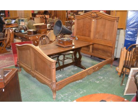 A French oak double bed, fielded panel head and footboards, cabriole legs with acanthus carved knees, shaped and chased side 