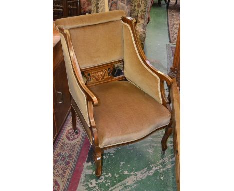 An Edwardian salon armchair, scrolling high sided back, padded toprail, shaped and pierced inlaid splat, serpentine front stu