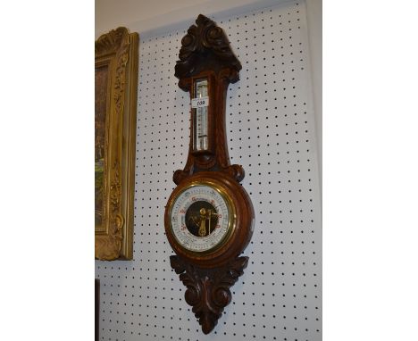 A Victorian carved oak aneroid wall barometer, integral thermometer, F Beardmore, Balam Hill SW, 65cm high
