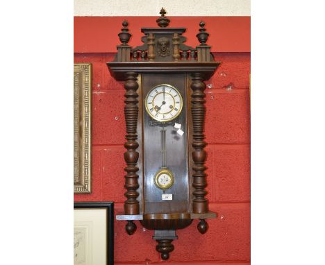 An early 20th century Vienna wall clock, moulded cresting, enamel dial with Roman numerals, 97cm high