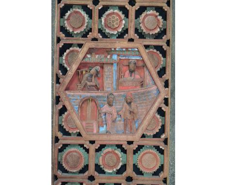 A Chinese carved wooden panel, hexagonal centre carved with four deities within a pierced floral border, character marks to v