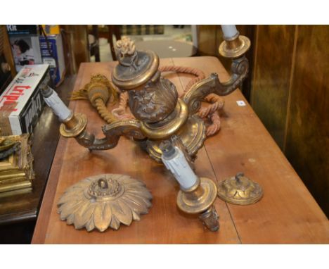 A carved Rococo style giltwood three branch ceiling light fitting; suspension rope 