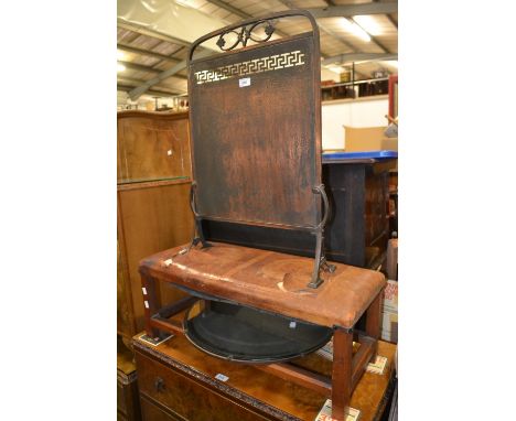 An Arts and Crafts copper fire screen; a leather top oak long stool; a circular wall mirror (3)