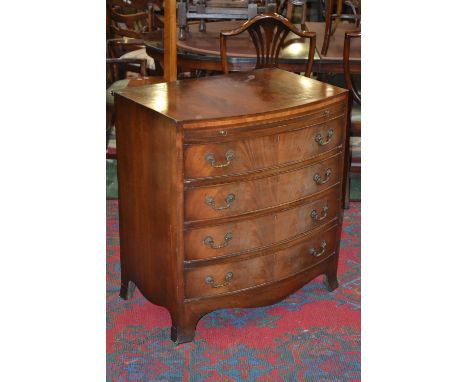 A George III style mahogany bow front bachelor's chest, crossbanded caddy top, brushing slid with axehead handles, four drawe
