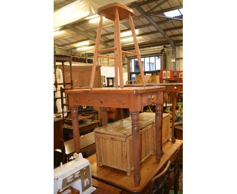 A small pine kitchen table, rounded rectangular top, single drawer to frieze, turned supports; a pine bar stool (2)