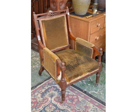 A Mahogany library chair, pierced top rail, acorn finialed reeded uprights, padded back and arms. padded seat, turned foreleg