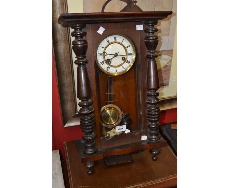 A 19th century Vienna clock, moulded pediment, pilasters and apron, Roman numerals, white enamel dial, 56.5cm high