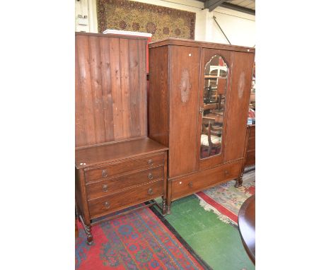 A 1920/30's bedroom suite comprising double wardrobe with central arched mirror door flanked by embossed panels, single deep 