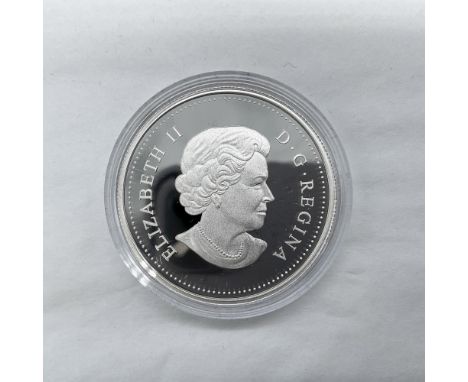 A 1 dollar Canadian coin. The obverse side features Queen Elizabeth II. The reverse side depicts soldiers getting off of a mi