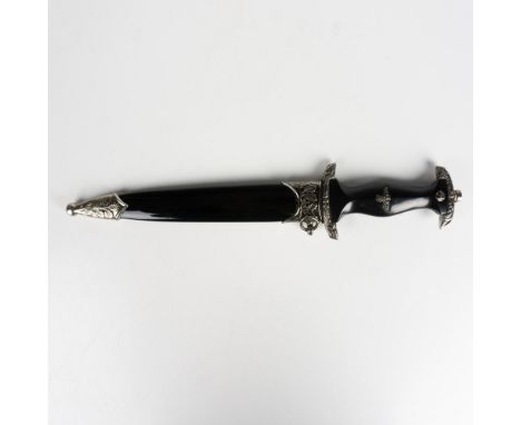 A typical style dagger with 8.5"L steel blade, silver-metal cross guard, and black grip. Handle features an eagle head design