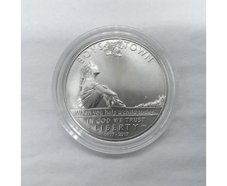 Philadelphia Mint. A commemorative issued coin. The obverse side depicts a young girl sitting alone. She is shown gazing up i