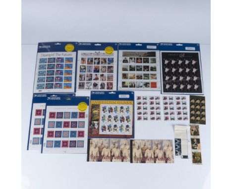 A collection of collectible postal stamps. 7 of which are in USPS original packaging, and 2 are United Nations United Nations