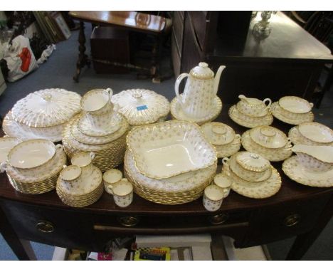 An extensive Spode gold coloured Fleur de Lys part dinner and coffee service, white background with gilt decoration, to inclu