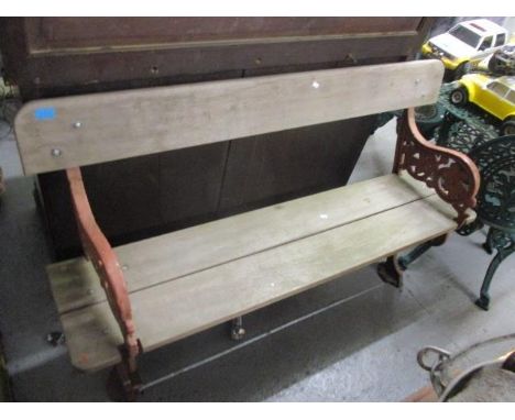 A cast metal garden bench and table with a marble top 