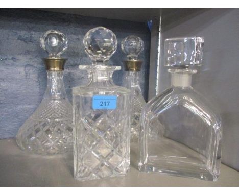 Four glass decanters to include a pair with silver collars, an Orrefors example and another 