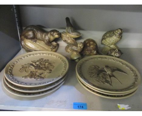 A collection of Poole stoneware pottery to include collectors plates, an otter and others 