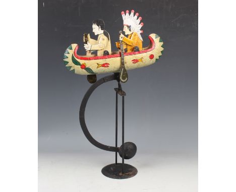 A polychrome painted metronomic automaton, modelled as two Native Americans paddling a canoe, raised on a black painted metal