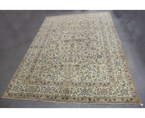 A signed Kashan carpet, Central Persia, mid/late 20th century, the celadon field with overall scrolling tendrils issuing palm